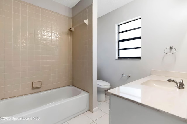 full bathroom featuring toilet, tiled shower / bath, tile patterned floors, and vanity