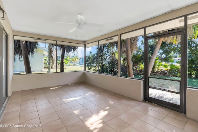 unfurnished sunroom with ceiling fan