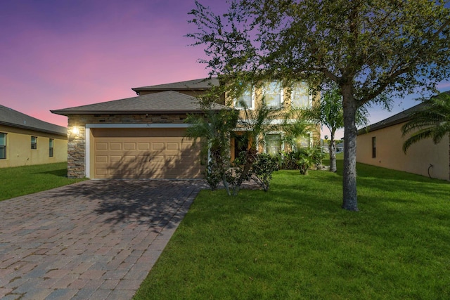 view of front of home with a yard and a garage