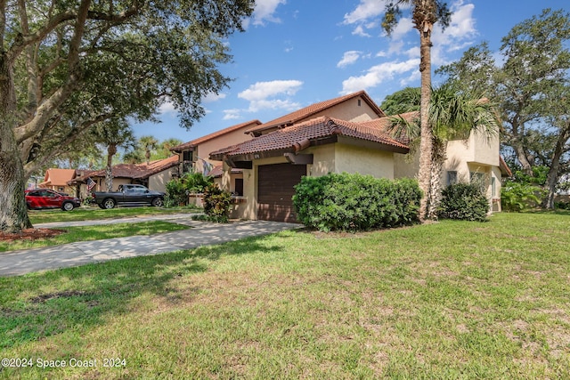 mediterranean / spanish-style home featuring a front yard