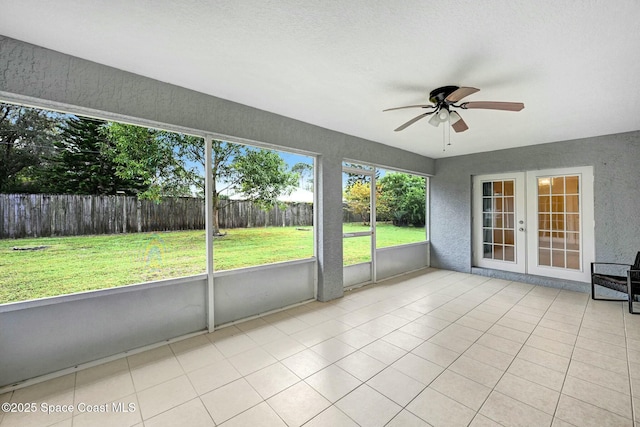 unfurnished sunroom with ceiling fan and french doors