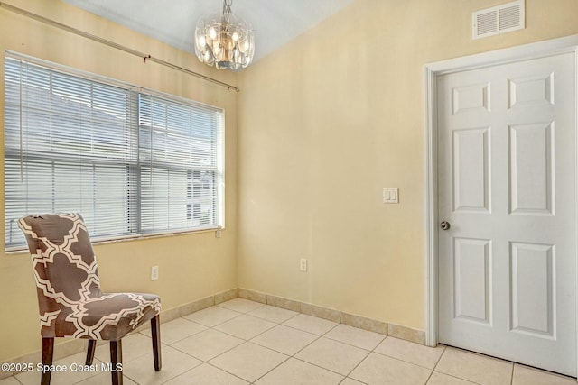 living area featuring light tile patterned floors and an inviting chandelier