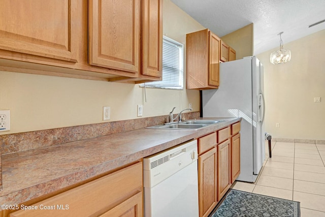 kitchen with white appliances, sink, decorative light fixtures, light tile patterned flooring, and a chandelier