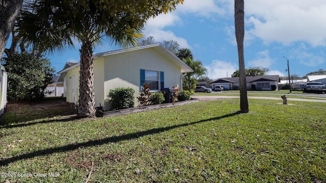 view of side of home featuring a lawn