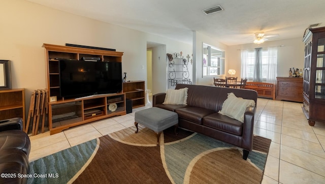 tiled living room with ceiling fan