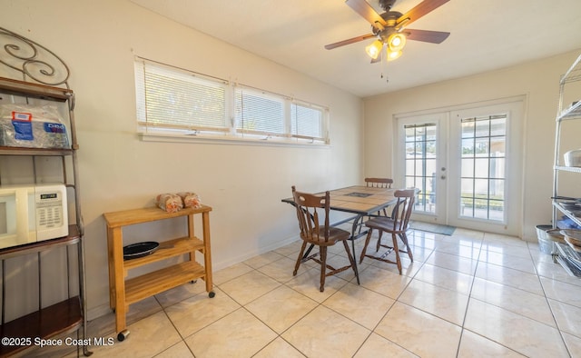 dining area with ceiling fan, light tile patterned floors, and french doors