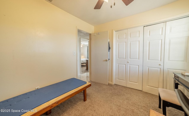 interior space featuring ceiling fan and a closet