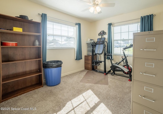 exercise room featuring light carpet and ceiling fan