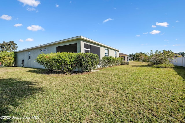 view of side of property with a lawn