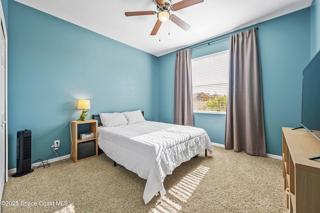 bedroom featuring ceiling fan and light carpet