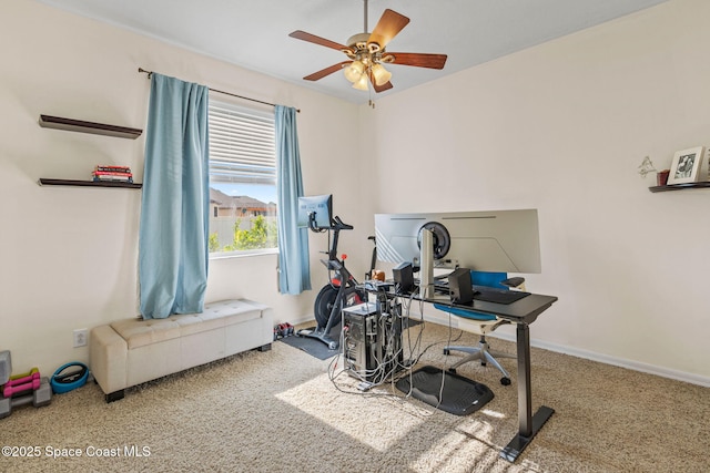 carpeted office featuring ceiling fan