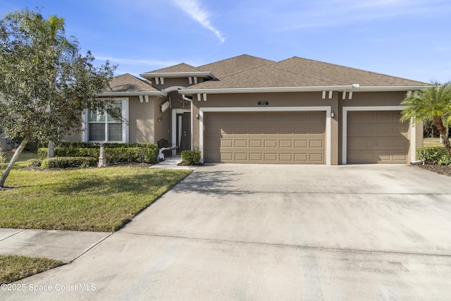 view of front of home featuring a front lawn and a garage