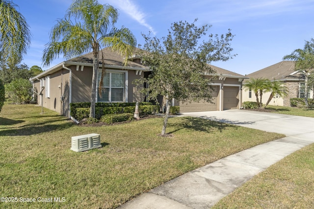 view of front of home with a front yard and a garage