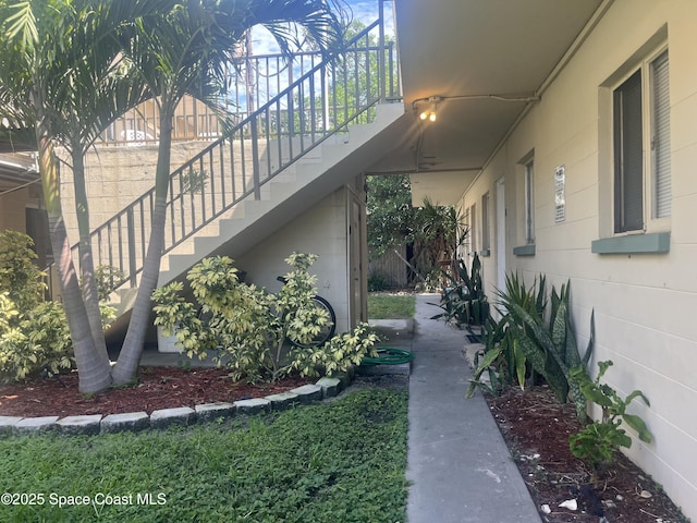 view of side of property featuring stairs