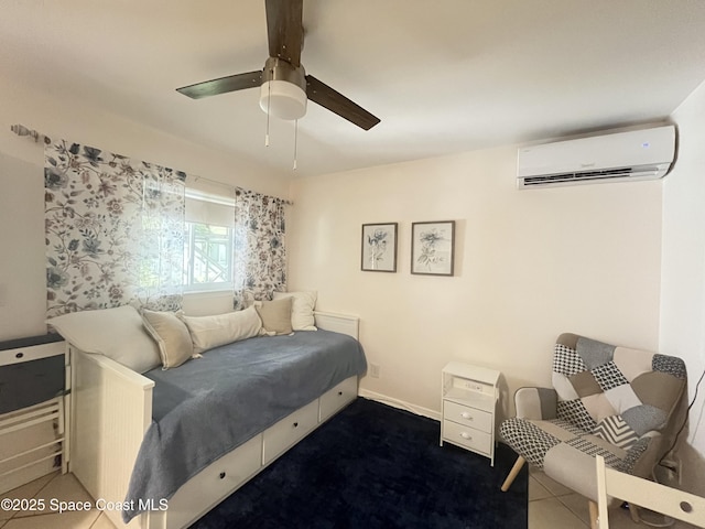 bedroom featuring a wall mounted air conditioner, a ceiling fan, and baseboards