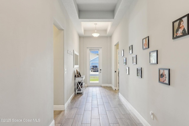 hallway with a tray ceiling