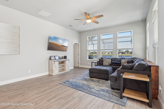 living room with ceiling fan and light hardwood / wood-style flooring