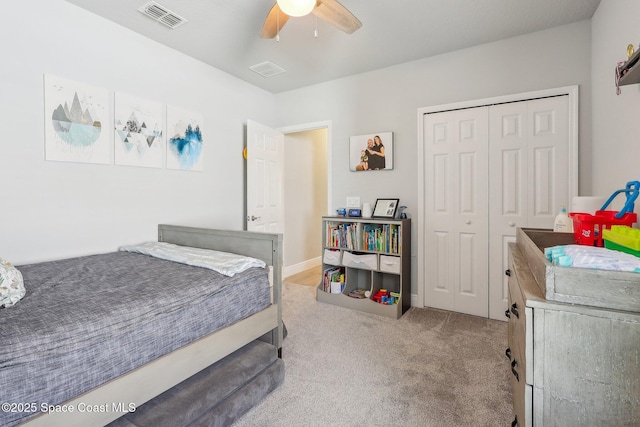 carpeted bedroom featuring ceiling fan and a closet