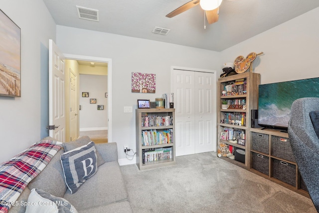 sitting room featuring ceiling fan and light colored carpet