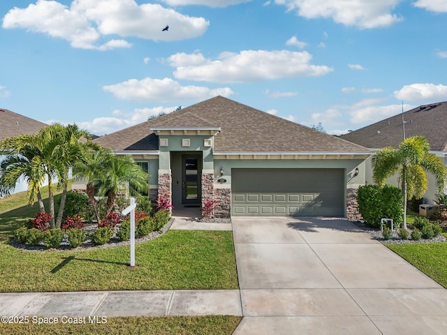 view of front of house featuring a front yard and a garage