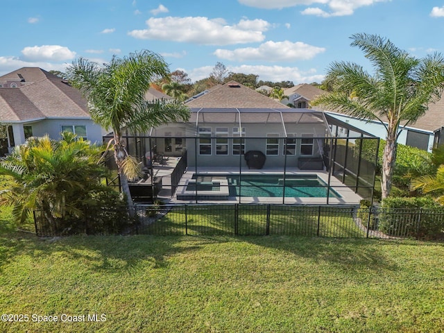 view of swimming pool featuring a yard, a patio, and a lanai