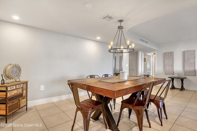 tiled dining area featuring an inviting chandelier