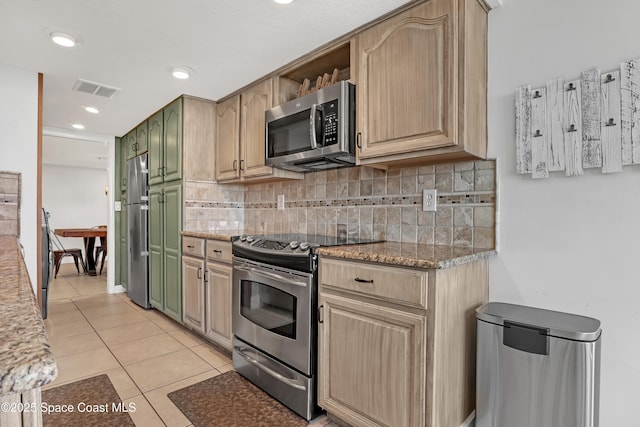 kitchen featuring light stone countertops, stainless steel appliances, decorative backsplash, light brown cabinetry, and light tile patterned floors