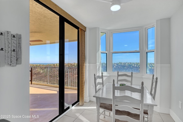 dining space featuring light tile patterned floors and a healthy amount of sunlight