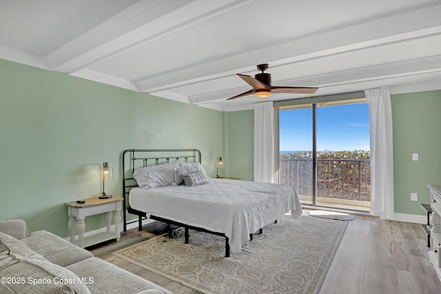 bedroom featuring ceiling fan, beam ceiling, access to exterior, and light hardwood / wood-style floors