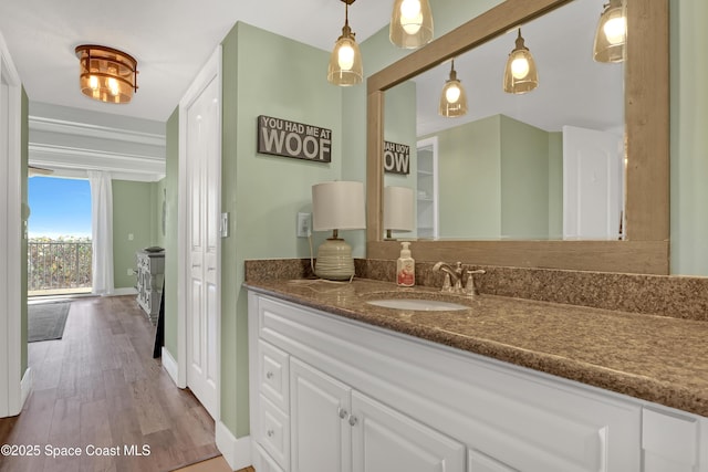 bathroom with beam ceiling, vanity, and hardwood / wood-style flooring