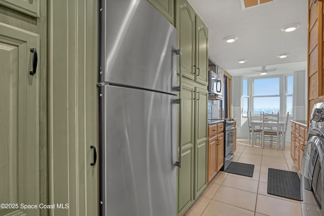 kitchen featuring light tile patterned floors and appliances with stainless steel finishes