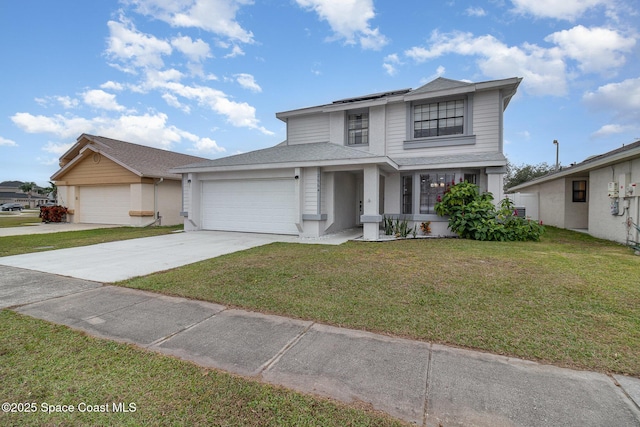 view of front of house featuring a front lawn and a garage