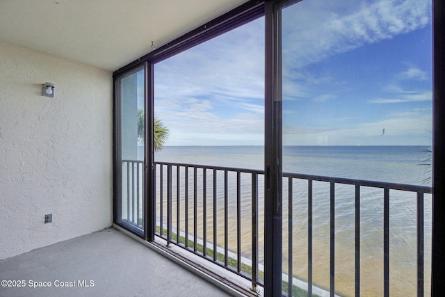 unfurnished sunroom featuring a water view and a healthy amount of sunlight