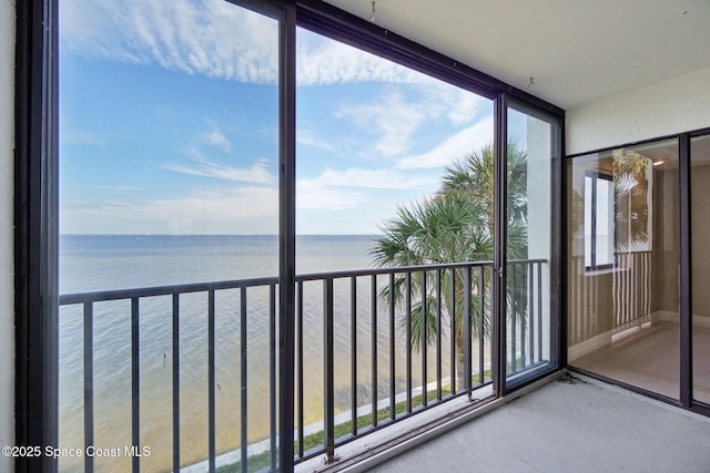 unfurnished sunroom with a water view