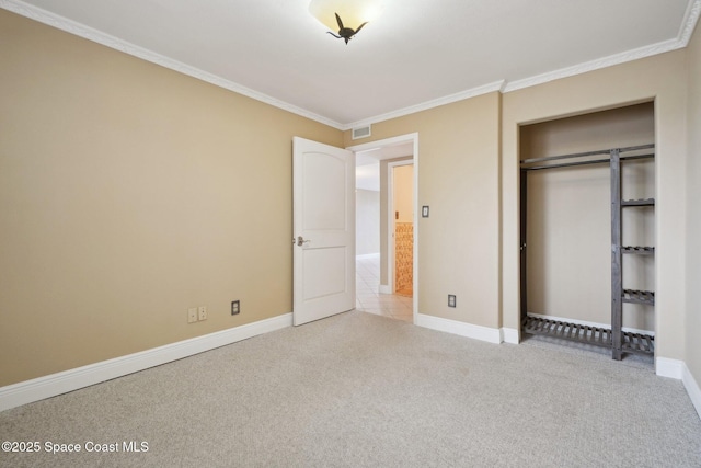 unfurnished bedroom featuring crown molding, a closet, and light carpet