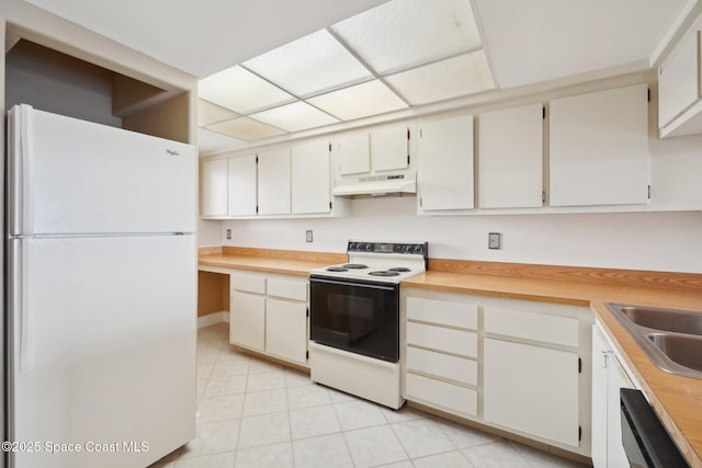 kitchen with custom range hood, white appliances, and white cabinetry