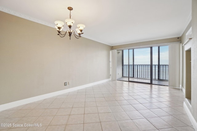 unfurnished room with a water view, light tile patterned floors, crown molding, and a chandelier