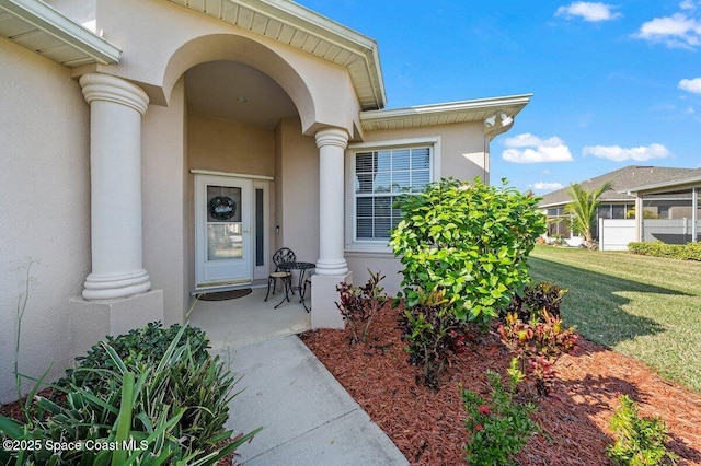 doorway to property with a yard