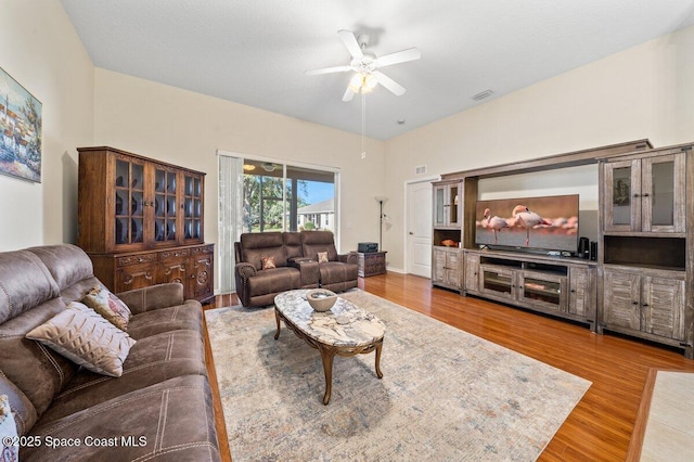 living room with ceiling fan and hardwood / wood-style flooring