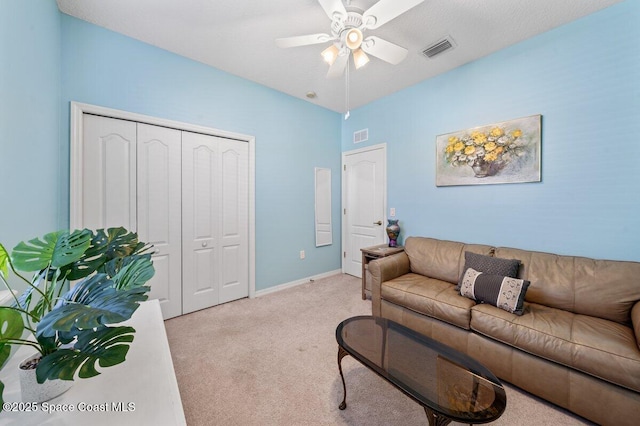 living room with ceiling fan and light carpet