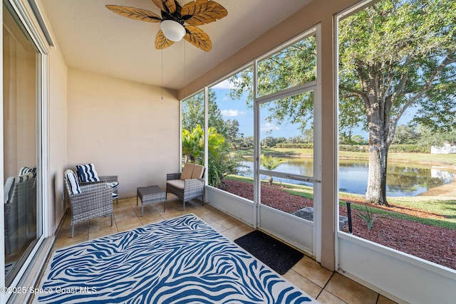 sunroom / solarium with a water view and ceiling fan