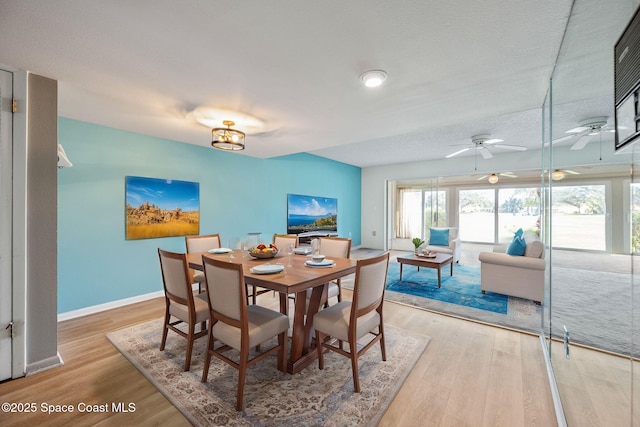 dining area featuring a textured ceiling, ceiling fan, and light hardwood / wood-style floors