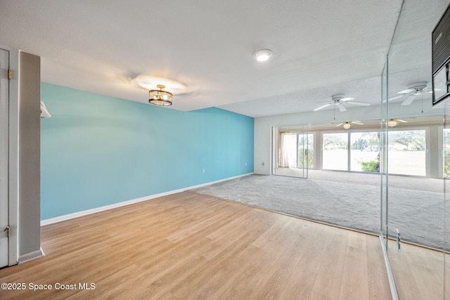 empty room featuring light hardwood / wood-style floors, a textured ceiling, and ceiling fan