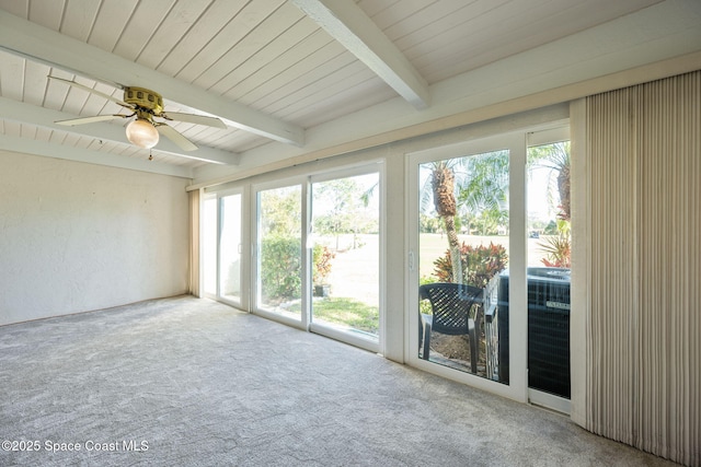 unfurnished sunroom featuring ceiling fan and beamed ceiling