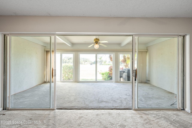 interior space featuring beam ceiling and ceiling fan