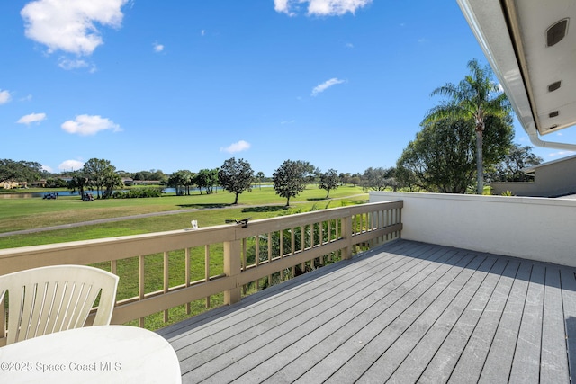 deck featuring a water view and a lawn