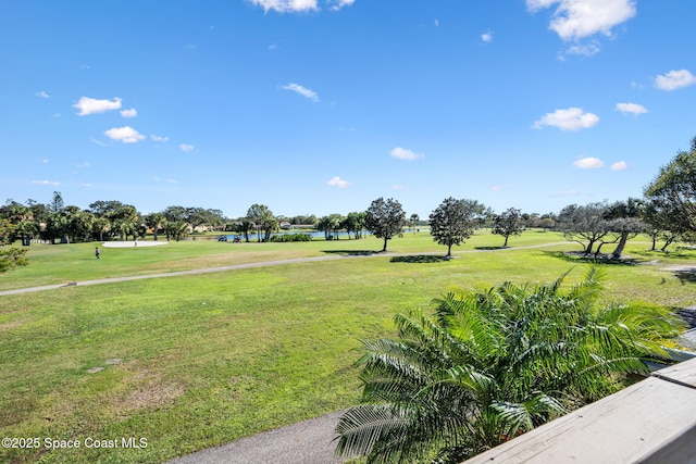 view of home's community featuring a lawn and a water view