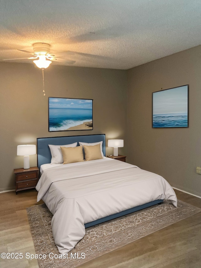 bedroom featuring a textured ceiling, ceiling fan, and hardwood / wood-style floors