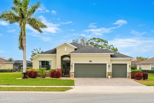 view of front of house with a garage and a front yard