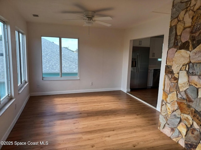 unfurnished room with ceiling fan and light hardwood / wood-style flooring